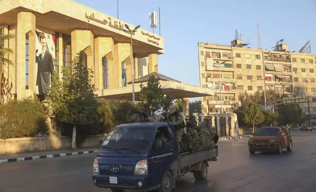 Opposition fighters ride along the streets of Aleppo, Syria, Saturday Nov. 30, 2024. (AP Photo/Ghaith Alsayed)