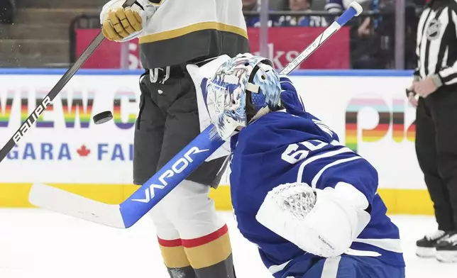 Vegas Golden Knights' Keegan Kolesar (55) evades the puck in front Toronto Maple Leafs' goaltender Joseph Woll (60) during first period NHL hockey action in Toronto, on Wednesday, November 20, 2024. (Chris Young/The Canadian Press via AP)