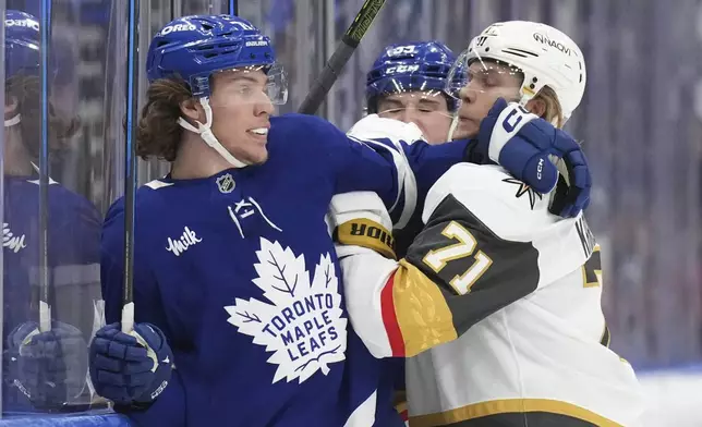 Toronto Maple Leafs Nikita Grebenkin (71) tangles on the boards with Vegas Golden Knights William Karlsson (71) during first period NHL hockey action in Toronto, on Wednesday, November 20, 2024. (Chris Young/The Canadian Press via AP)