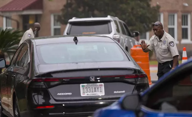 Police inspect vehicles for identification as they enter Tuskegee University, Monday, Nov. 11, 2024, in Tuskegee, Ala. (AP Photo/Mike Stewart)