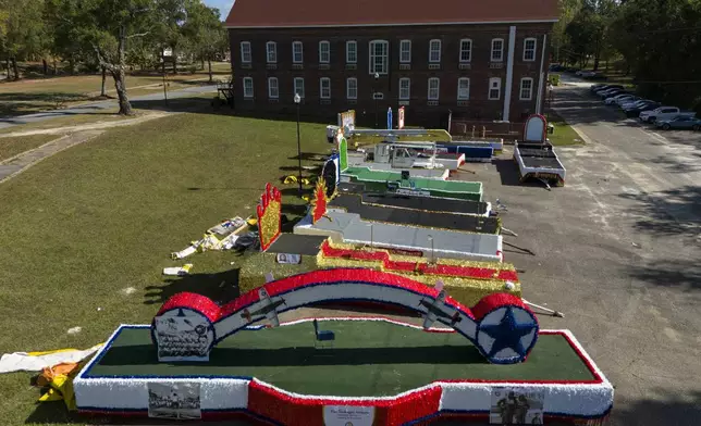 Homecoming parade floats sit on the campus of Tuskegee University a day after a shooting occurred, Monday, Nov. 11, 2024, in Tuskegee, Ala. (AP Photo/Mike Stewart)