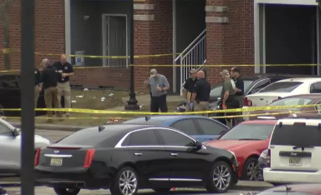 This image taken from video provided by WSFA shows law enforcement working at the scene of a shooting at Tuskegee University, Sunday, Nov. 10, 2024, in Tuskegee, Ala. (WSFA via AP)