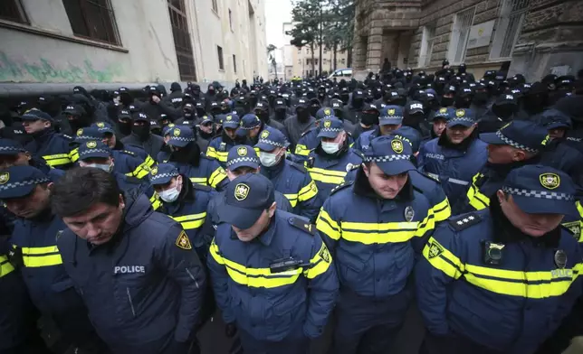 Police block a street during a rally to demand new parliamentary elections in the country, near the Parliament's building in Tbilisi, Georgia, Monday, Nov. 25, 2024. (AP Photo/Zurab Tsertsvadze)