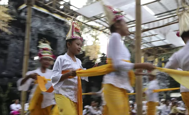 Ketut Nita Wahyuni, 11, performs the Rehang Dewa, a sacred Balinese dance, at Geriana Kauh village, Karangasem, Bali, Indonesia on Wednesday, Nov. 20, 2024. (AP Photo/Firdia Lisnawati)