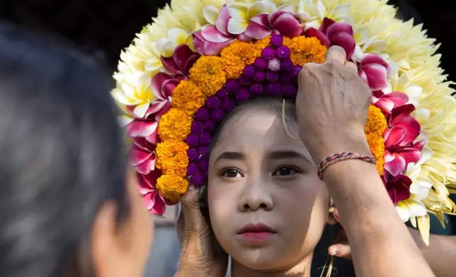 Ketut Nita Wahyuni is dressed up to participate in Rejang Pucuk Hindu ritual ceremony at Geriana Kauh village, Karangasem, Bali, Indonesia, Thursday, Nov. 21, 2024. (AP Photo/Firdia Lisnawati)