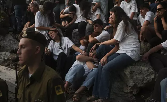 Mourners react during eulogies for Israeli soldier Capt. Itay Marcovich, who was killed in action in Lebanon, during his funeral in Kokhav Yair, Israel, Thursday, Nov. 14, 2024. (AP Photo/Ohad Zwigenberg)