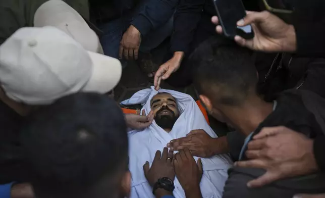 Palestinians mourn their relatives killed in the Israeli bombardment of Maghazi in the Gaza Strip, during their funeral at a hospital morgue in Deir al-Balah, Gaza, Thursday, Nov. 14, 2024. (AP Photo/Abdel Kareem Hana)