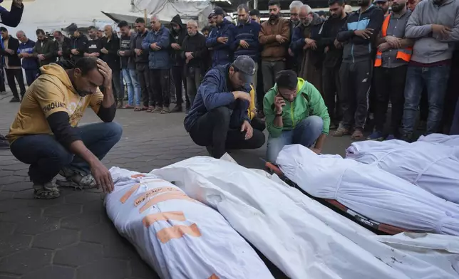 Palestinians mourn their relatives killed in the Israeli bombardment of Maghazi in the Gaza Strip, during their funeral at a hospital morgue in Deir al-Balah, Gaza, Thursday, Nov. 14, 2024. (AP Photo/Abdel Kareem Hana)