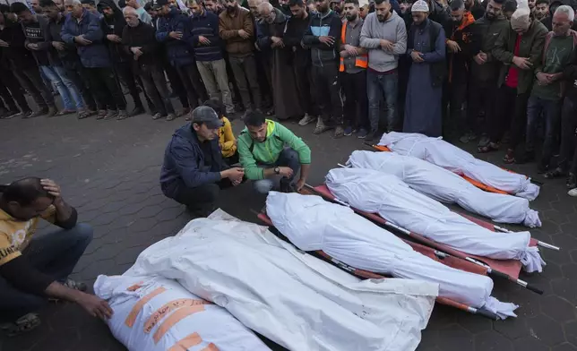 Palestinians mourn their relatives killed in the Israeli bombardment of Maghazi in the Gaza Strip, during their funeral at a hospital morgue in Deir al-Balah, Gaza, Thursday, Nov. 14, 2024. (AP Photo/Abdel Kareem Hana)