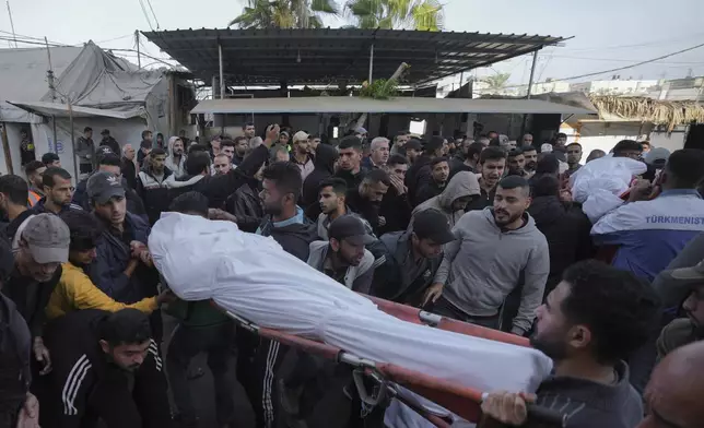 Mourners carry their relatives who were killed in the Israeli bombardment of Maghazi in the Gaza Strip, during their funeral in Deir al-Balah, Gaza, Thursday, Nov. 14, 2024. (AP Photo/Abdel Kareem Hana)