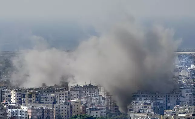 Smoke rises between buildings hit in an Israeli airstrike in Dahiyeh, in the southern suburb of Beirut, Lebanon, Thursday, Nov. 14, 2024. (AP Photo/Hussein Malla)