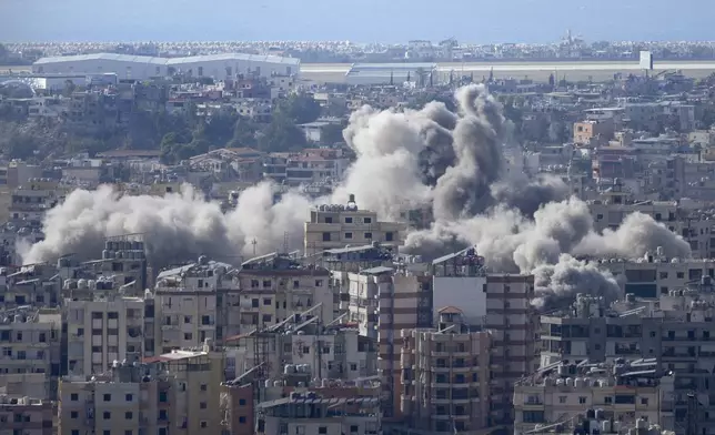 Smoke rises between buildings hit in an Israeli airstrike in Dahiyeh, in the southern suburb of Beirut, Lebanon, Thursday, Nov. 14, 2024. (AP Photo/Hussein Malla)