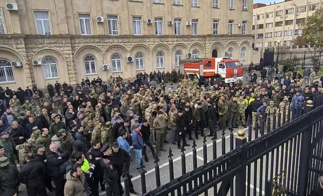 In this photo taken from video released by AIASHARA Independent Agency, Protesters gather outside the parliament building of the Georgian separatist region of Abkhazia as tensions flared over a proposed pact that would allow Russians to buy apartments in the region, Georgia, on Friday, Nov. 15, 2024, (AIASHARA Independent Agency via AP)