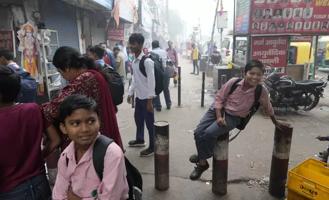 School children play as they return from the school that was closed as air pollution shoots up in New Delhi, India, Monday, Nov. 18, 2024. (AP Photo/Manish Swarup)