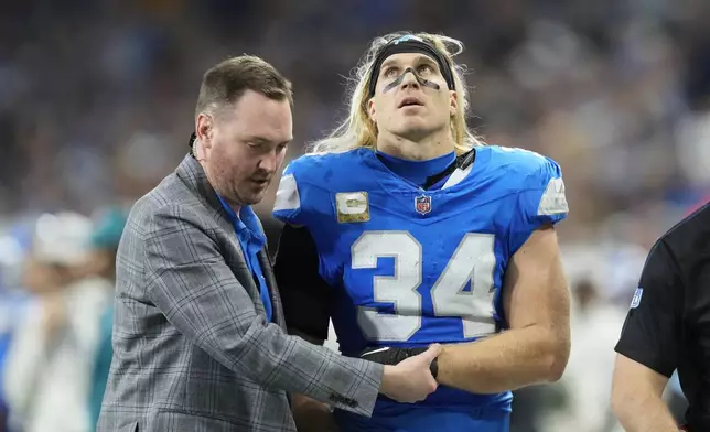 Detroit Lions linebacker Alex Anzalone (34) is attended by medical staff during the first half of an NFL football game against the Jacksonville Jaguars, Sunday, Nov. 17, 2024, in Detroit. (AP Photo/Carlos Osorio)