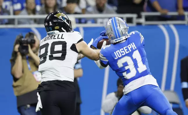 Detroit Lions safety Kerby Joseph (31) intercepts a pass intended for Jacksonville Jaguars tight end Luke Farrell (89) during the second half of an NFL football game, Sunday, Nov. 17, 2024, in Detroit. (AP Photo/Duane Burleson)