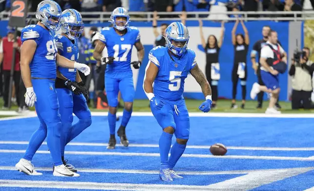 Detroit Lions running back David Montgomery (5) celebrates his two-yard touchdown run against the Jacksonville Jaguars during the first half of an NFL football game, Sunday, Nov. 17, 2024, in Detroit. (AP Photo/Carlos Osorio)