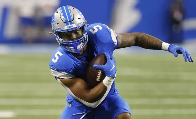 Detroit Lions running back David Montgomery (5) runs the ball against the Jacksonville Jaguars during the first half of an NFL football game, Sunday, Nov. 17, 2024, in Detroit. (AP Photo/Duane Burleson)