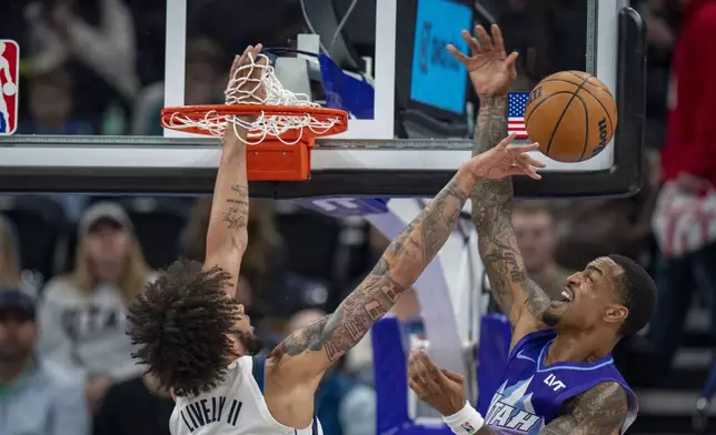 Dallas Mavericks center Dereck Lively II, blocks a shot by Utah Jazz forward John Collins, during the first half of an NBA basketball game Thursday, Nov. 14, 2024, in Salt Lake City. (AP Photo/Rick Egan)