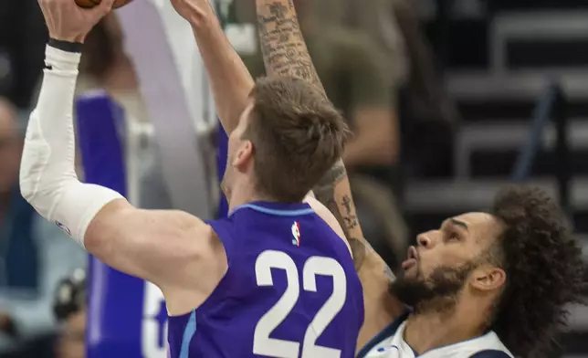 Utah Jazz forward Kyle Filipowski (22) shoots as Dallas Mavericks center Dereck Lively II (2) defends during the first half of an NBA basketball game Thursday, Nov. 14, 2024, in Salt Lake City. (AP Photo/Rick Egan)