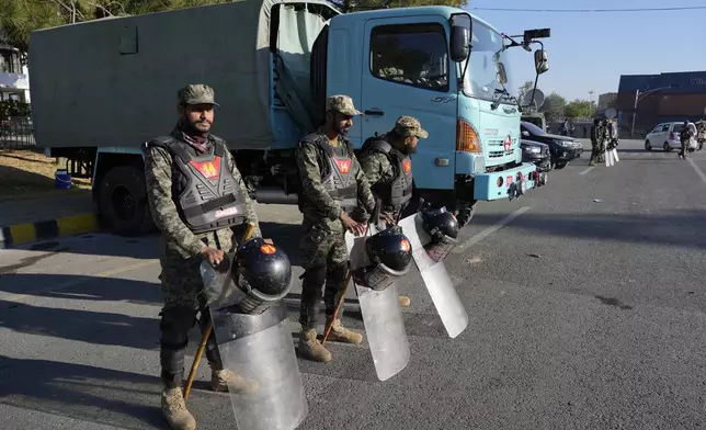 Paramilitary soldiers stand guard along roadside to ensure security in Islamabad, Pakistan, Wednesday, Nov. 27, 2024. (AP Photo/Anjum Naveed)