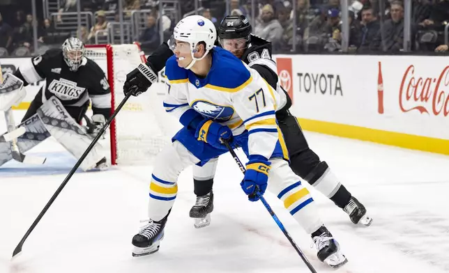 Los Angeles Kings defenseman Vladislav Gavrikov, right, chases Buffalo Sabres right wing JJ Peterka during the first period of an NHL hockey game Wednesday, Nov. 20, 2024, in Los Angeles, Calif. (AP Photo/Ryan Sun)