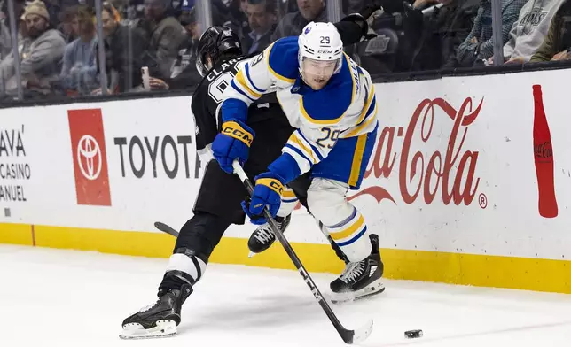 Buffalo Sabres left wing Beck Malenstyn, right, and Los Angeles Kings defenseman Brandt Clarke vie for the puck during the first period of an NHL hockey game Wednesday, Nov. 20, 2024, in Los Angeles, Calif. (AP Photo/Ryan Sun)