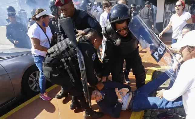 FILE - An anti-government protester is detained by police as security forces disrupt an opposition march coined "United for Freedom" in Managua, Nicaragua, Oct. 14, 2018. (AP Photo/Alfredo Zuniga, File)