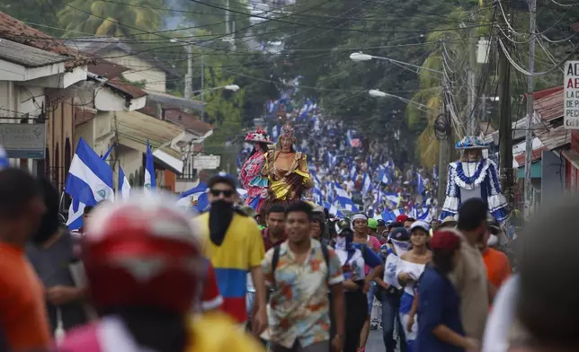 FILE - Anti-government demonstrators march against President Daniel Ortega and for the release of all political prisoners, in Leon, Nicaragua, July 28, 2018. (AP Photo/Alfredo Zuniga, File)