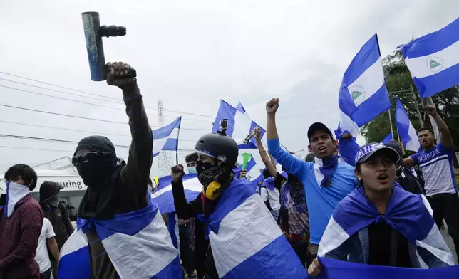 FILE - Students and activists protest outside the Jesuit run Central American University in Managua, Nicaragua, Aug. 2, 2018. (AP Photo/Arnulfo Franco, File)