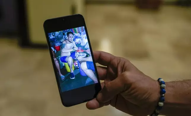 Exiled Nicaraguan Sergio Mena shows a September 2023 photo of himself while imprisoned in a Nicaraguan jail, during an interview in Guatemala City, Wednesday, Oct. 16, 2024. (AP Photo/Moises Castillo)