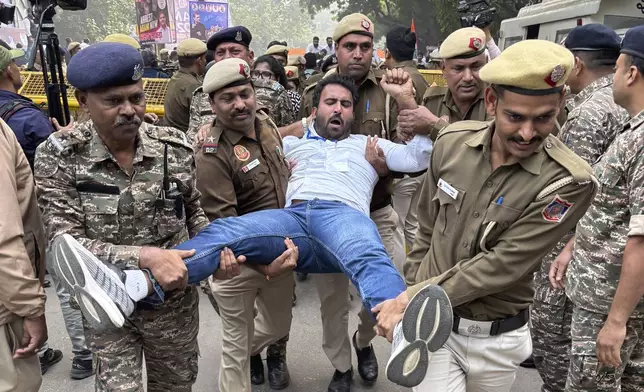 Police detain a Congress party supporter during a protest against Indian billionaire Gautam Adani and Indian Prime Minister Narendra Modi after Adani was indicted by U.S. prosecutors for bribery and fraud, in New Delhi, India, Monday, Nov. 25, 2024. (AP Photo/Shonal Ganguly)