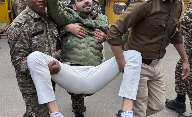 Police detain a Congress party supporter participating during a protest against Indian billionaire Gautam Adani and Indian Prime Minister Narendra Modi, after Adani was indicted by U.S. prosecutors for bribery and fraud, in New Delhi, India, Monday, Nov. 25, 2024. (AP Photo/Shonal Ganguly)