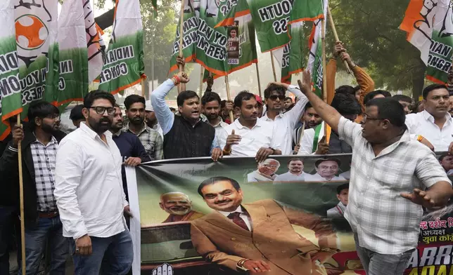 India's opposition Congress party members shout slogans during a protest against Indian billionaire Gautam Adani and Indian Prime Minister Narendra Modi after Adani was indicted by U.S. prosecutors for bribery and fraud, in New Delhi, India, Monday, Nov. 25, 2024. (AP Photo/Manish Swarup)