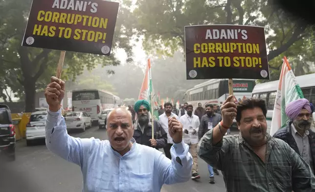 India's opposition Congress party members shout slogans during a protest against Indian billionaire Gautam Adani and Indian Prime Minister Narendra Modi after Adani was indicted by U.S. prosecutors for bribery and fraud, in New Delhi, India, Monday, Nov. 25, 2024. (AP Photo/Manish Swarup)