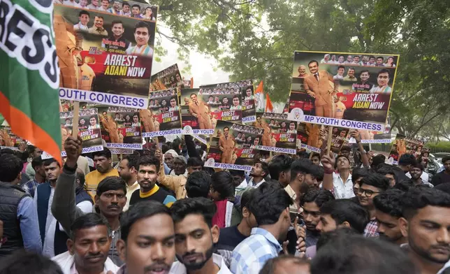 India's opposition Congress party members shout slogans during a protest against Indian billionaire Gautam Adani and Indian Prime Minister Narendra Modi after Adani was indicted by U.S. prosecutors for bribery and fraud, in New Delhi, India, Monday, Nov. 25, 2024. (AP Photo/Manish Swarup)