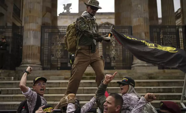 Demonstrators march against the government of President Gustavo Petro, in Bogotá, Colombia, Saturday, Nov. 23, 2024. (AP Photo/Ivan Valencia)