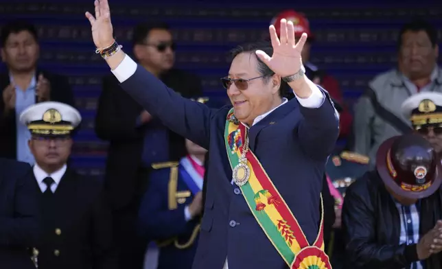 FILE - Bolivian President Luis Arce waves to supporters outside the government palace marking his fifth year in office, in La Paz, Bolivia, Nov. 8, 2024. (AP Photo/Juan Karita, File)