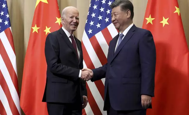 President Joe Biden shakes hands with Chinese President Xi Jinping before a bilateral meeting, Saturday, Nov. 16, 2024, in Lima, Peru. (Leah Millis/Pool Photo via AP)