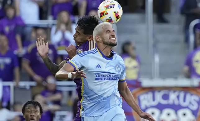 Atlanta United's Luis Abram, center right, and Orlando City's Facundo Torres, center left, go up for control of a head ball during the first half of an MLS Semifinal Conference playoff soccer match, Sunday, Nov. 24, 2024, in Orlando, Fla. (AP Photo/John Raoux)