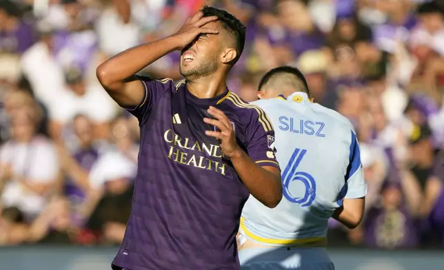 Orlando City's Martin Ojeda, left, reacts after missing a shot on goal against Atlanta United during the first half of an MLS Semifinal Conference playoff soccer match, Sunday, Nov. 24, 2024, in Orlando, Fla. (AP Photo/John Raoux)