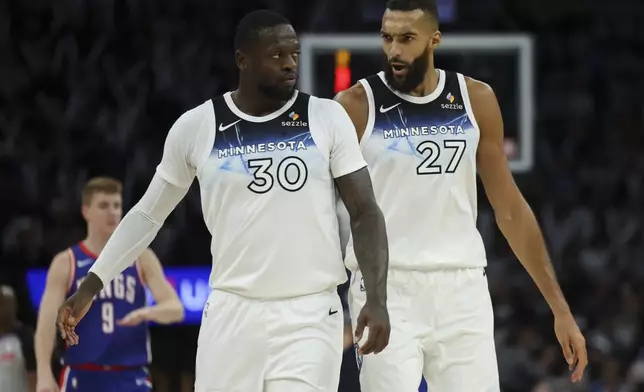 Minnesota Timberwolves forward Julius Randle (30) and center Rudy Gobert (27) react during the second half of an NBA basketball game against the Sacramento Kings, Wednesday, Nov. 27, 2024, in Minneapolis. (AP Photo/Ellen Schmidt)