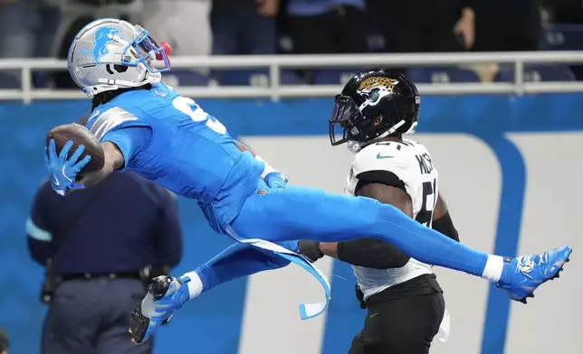 Detroit Lions wide receiver Jameson Williams (9) celebrates his 64-yard touchdown reception against the Jacksonville Jaguars during the second half of an NFL football game, Sunday, Nov. 17, 2024, in Detroit. (AP Photo/Carlos Osorio)