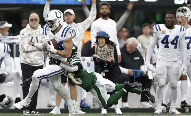 Indianapolis Colts wide receiver Alec Pierce (14) makes a catch against New York Jets safety Jalen Mills (35) for a first down during the fourth quarter of an NFL football game, Sunday, Nov. 17, 2024, in East Rutherford, N.J. (AP Photo/Adam Hunger)