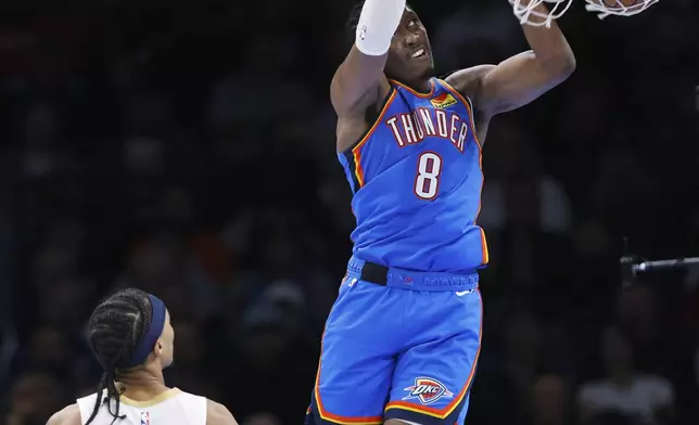 Oklahoma City Thunder forward Jalen Williams (8) dunks as New Orleans Pelicans guard Brandon Boston Jr. (11) watches during the second half of an NBA basketball game Wednesday, Nov. 13, 2024, in Oklahoma City. (AP Photo/Nate Billings)