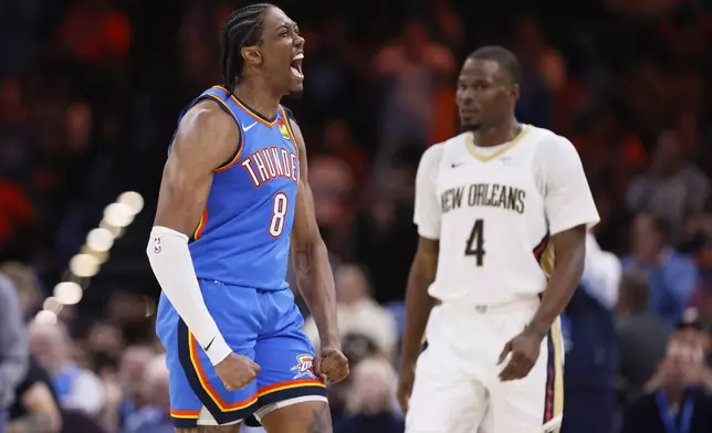 Oklahoma City Thunder forward Jalen Williams (8) celebrates near New Orleans Pelicans guard Javonte Green (4) during the second half of an NBA basketball game Wednesday, Nov. 13, 2024, in Oklahoma City. (AP Photo/Nate Billings)