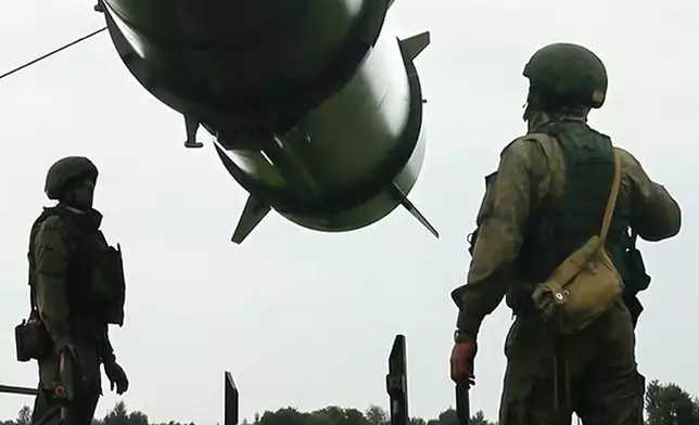 FILE - In this photo taken from video released by the Russian Defense Ministry Press Service on Wednesday, June 12, 2024, Russian soldiers load a Iskander-M short-range ballistic missile launchers at a firing position as part of Russian military drill intended to train the troops in using tactical nuclear weapons. (Russian Defense Ministry Press Service via AP, File)