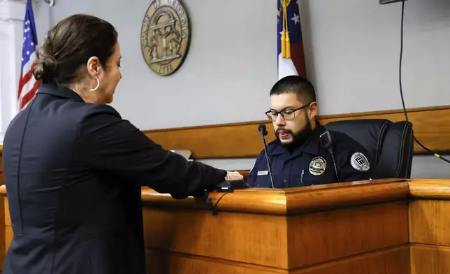 Prosecutor Sheila Ross speaks to the University of Georgia Police Rafael Sayan during the second day of the trial of Jose Ibarra at Athens-Clarke County Superior Court on Monday, Nov. 18, 2024, in Athens, Ga. (Miguel Martinez/Atlanta Journal-Constitution via AP, Pool)