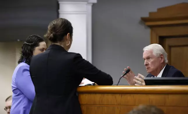 Superior Court Judge H. Patrick Haggard, right, confers with prosecutors and attorneys for Jose Ibarra during the second day of the trial of Jose Ibarra at Athens-Clarke County Superior Court on Monday, Nov. 18, 2024, in Athens, Ga. (Miguel Martinez/Atlanta Journal-Constitution via AP, Pool)