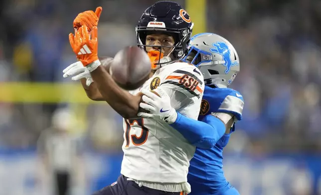Chicago Bears wide receiver Rome Odunze (15) can't catch a pass as Detroit Lions cornerback Terrion Arnold (0) defends during the second half of an NFL football game in Detroit, Thursday, Nov. 28, 2024. (AP Photo/Carlos Osorio)